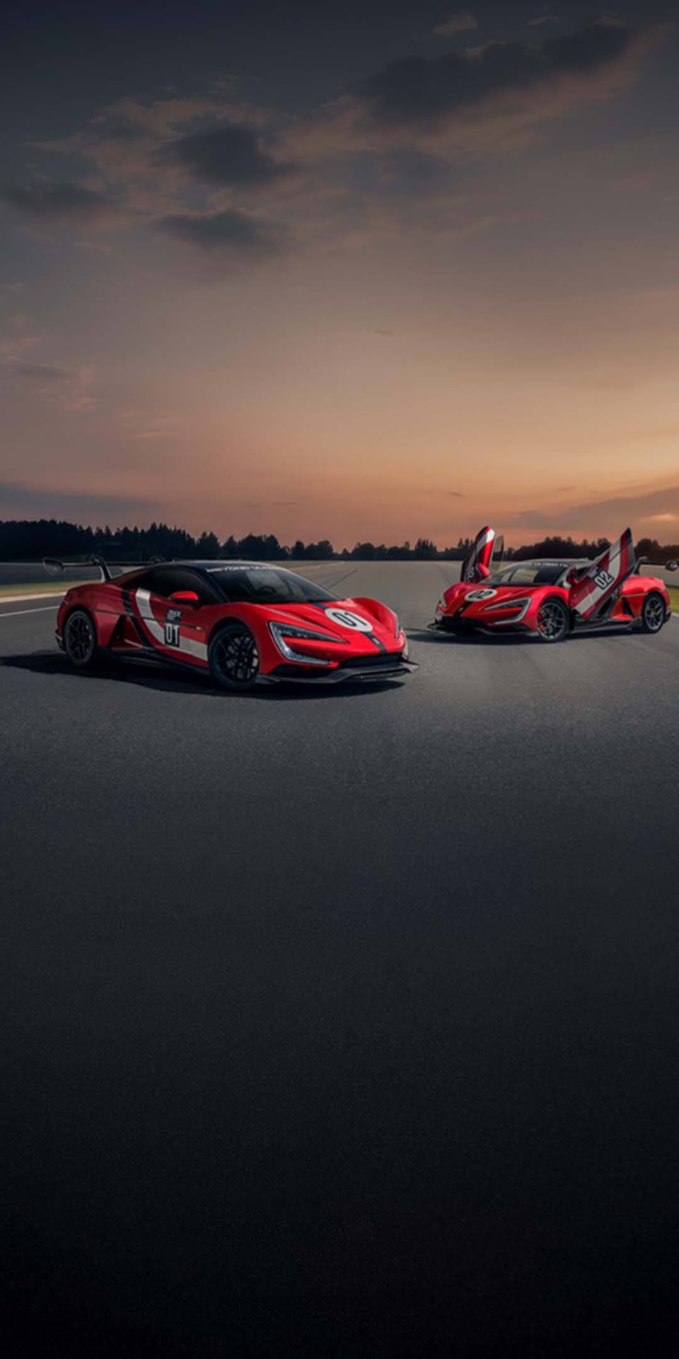 BYD performance cars on a race track at sunset